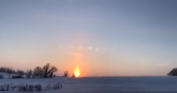 This is just a natural sky phenomenon? Sun pillar with triangular clouds above the pillar? Sun-pillar-circle-triangular-clouds